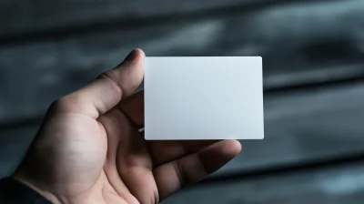 Empty white business card held by a male hand