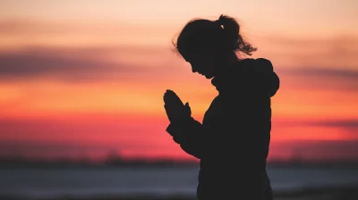 Silhouette of a Woman Praying at Sunset