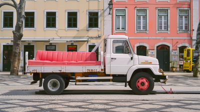 Tow truck with pink sofa on Lisbon square